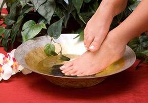 Bath with household soap against the foot mushroom